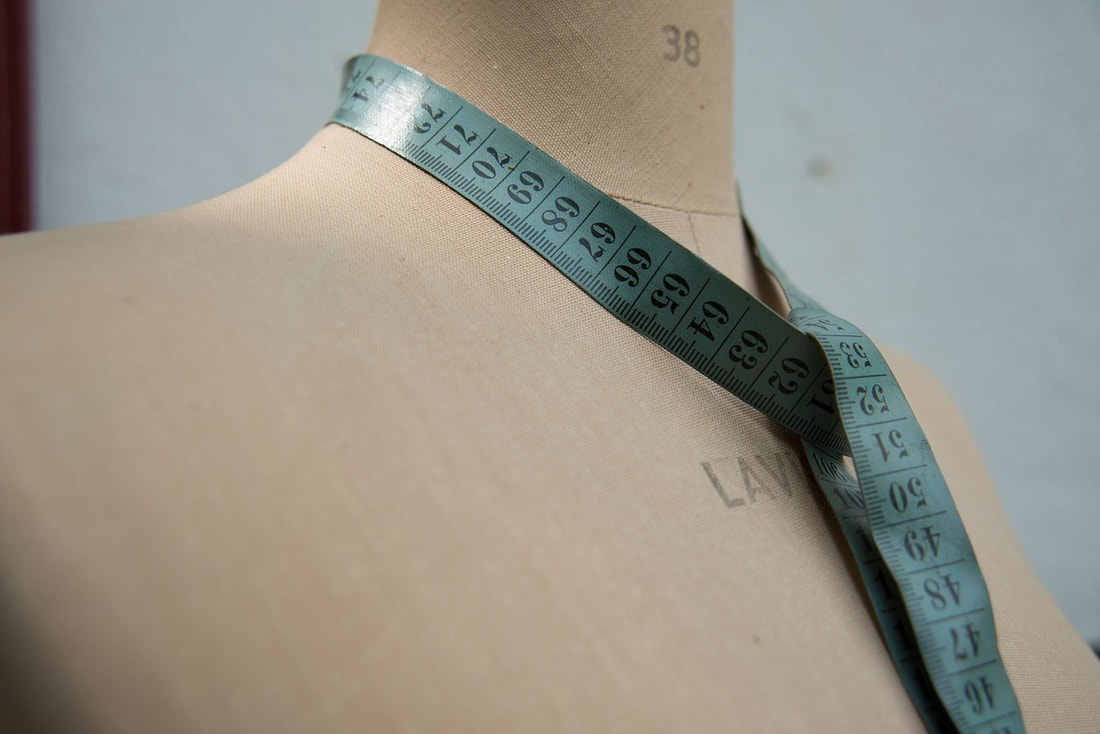 Dress form with measuring tape