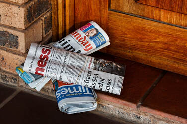 Newspapers on doorstep