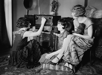Girls listening to the radio during the 1920s