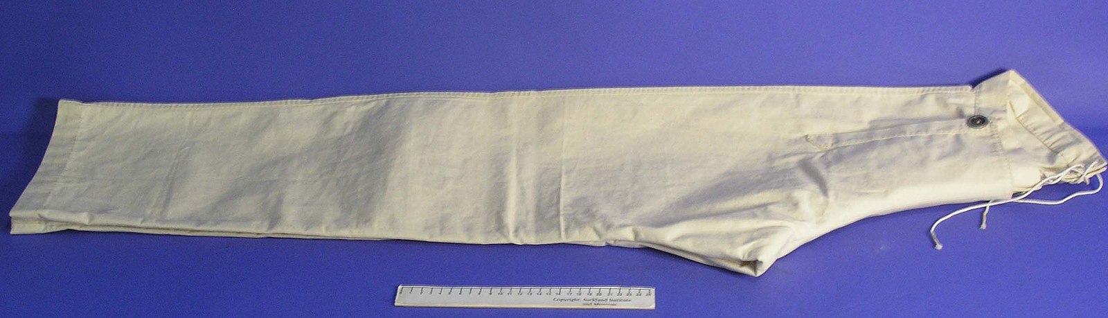 Trousers lying next to a ruler